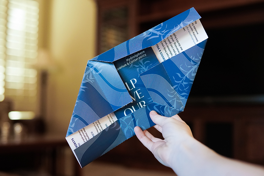the blue and white hydrosphere aquarium envelope opened halfway, showing the folds involved